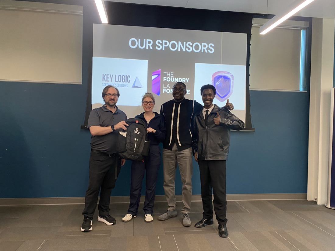 Team Ctrl+Alt+Defeat receiving the Best UI/UX award with Cambrian swag